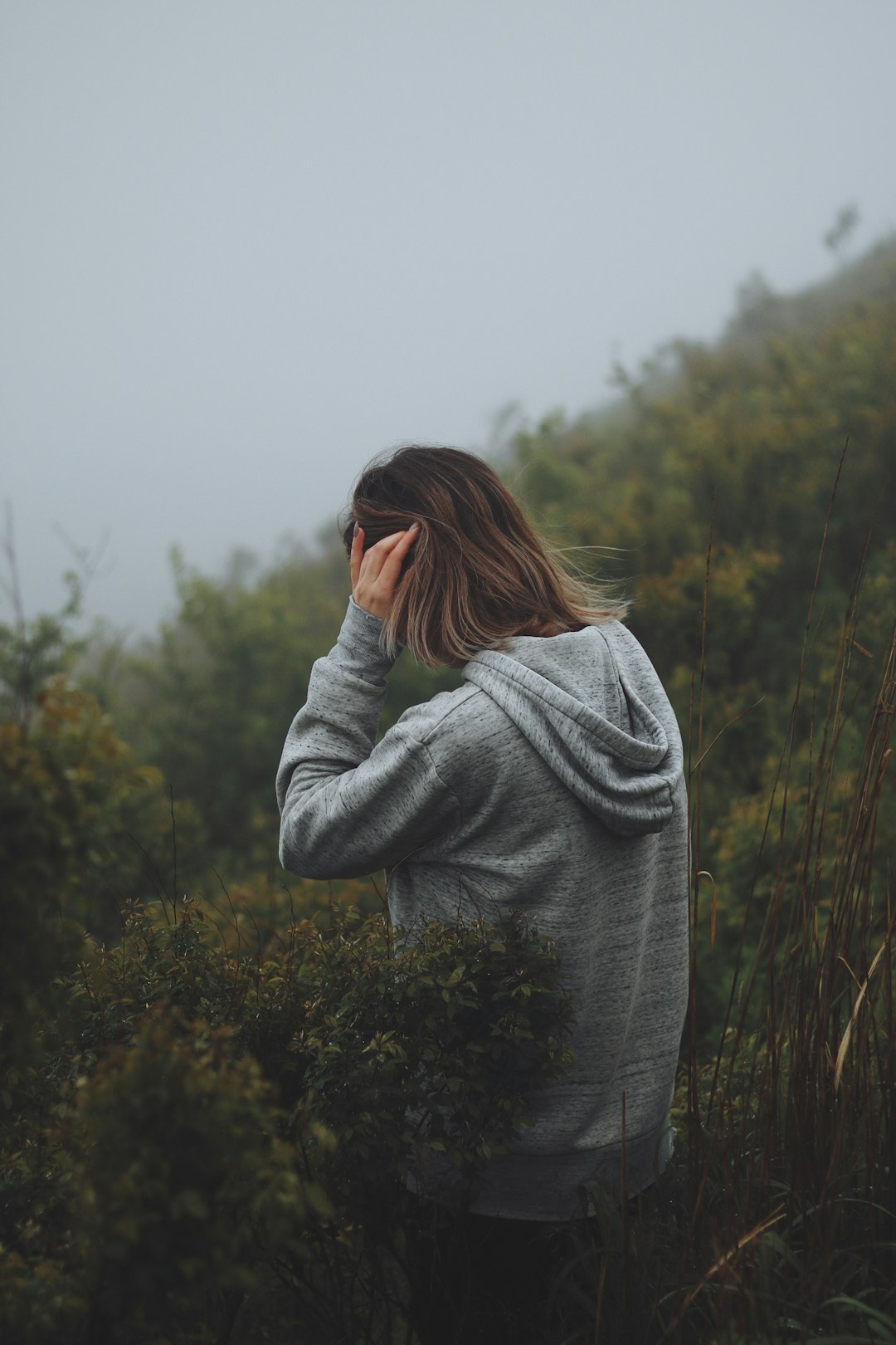 woman wearing grey hoodie